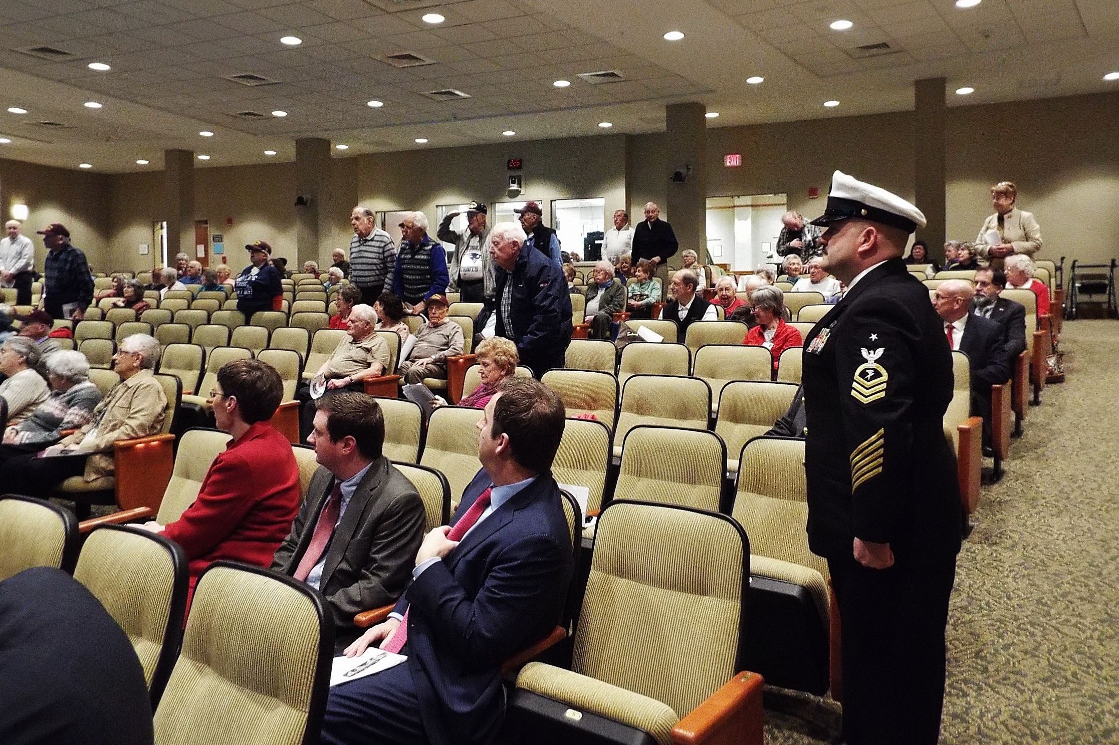 Senior Petty Officer, Keith Jermyn and other Navy Veterans stand to the official Navy song, 